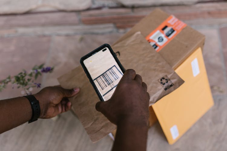 Deliveryman Scanning The Barcode