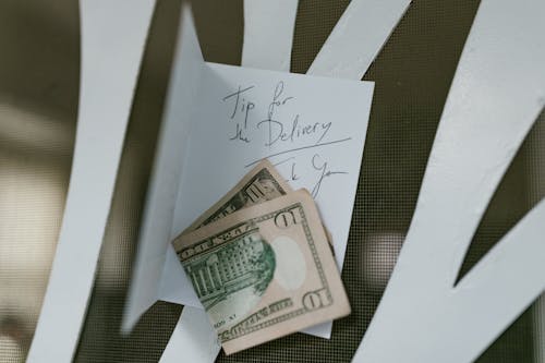 Woman Holding Fan of US Dollar Bills · Free Stock Photo