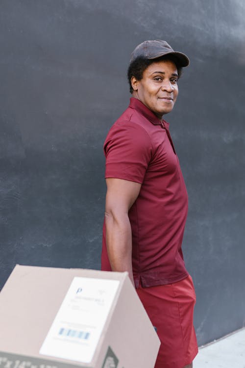 Free A Deliveryman Carrying a Package Stock Photo