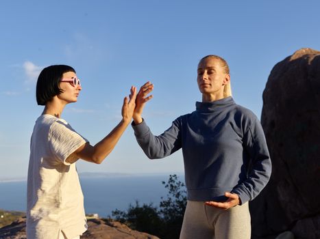 Women Playing with Energy against Blue Sea and Sky