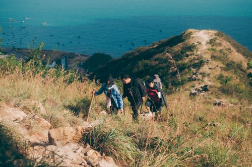 Free A group hiking on a sunny trail with ocean views in Nha Trang, Vietnam. Stock Photo