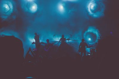 Band performing on smoke-filled stage