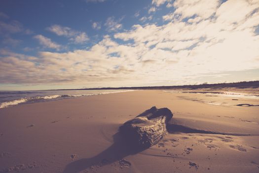 Tranquil beach scene, sunset over a sandy shore in Skórka, Poland.