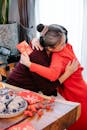 Unrecognizable granddaughter embracing Asian grandma during New Year holiday