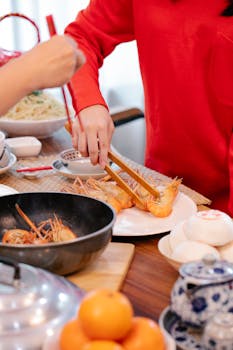 Hands preparing prawns in a lively Chinese kitchen setting. Perfect for culinary themes.