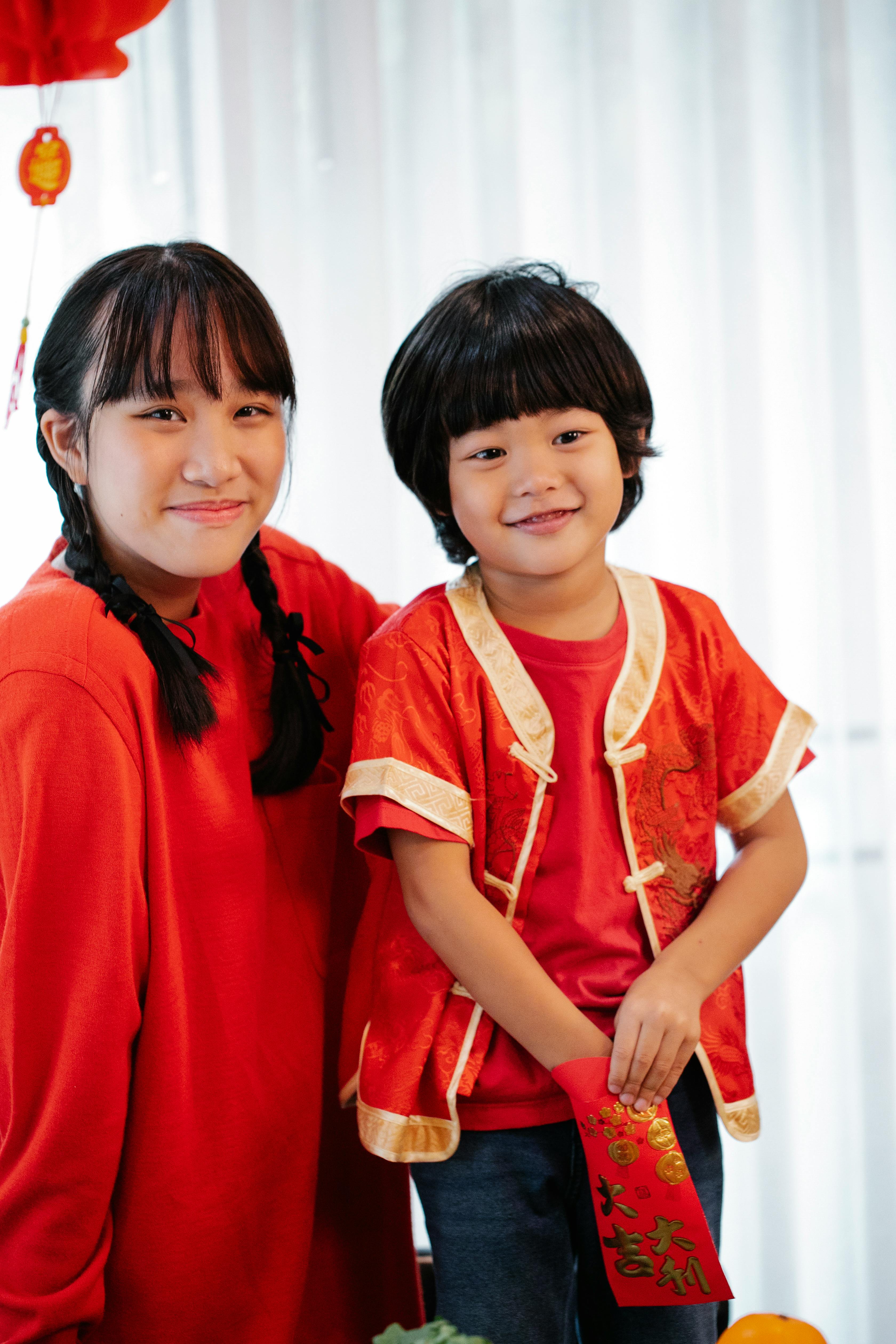 siblings wearing red clothes