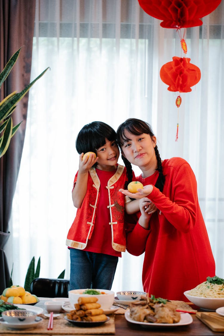 Asian Teen With Brother Showing Buns During New Year Holiday