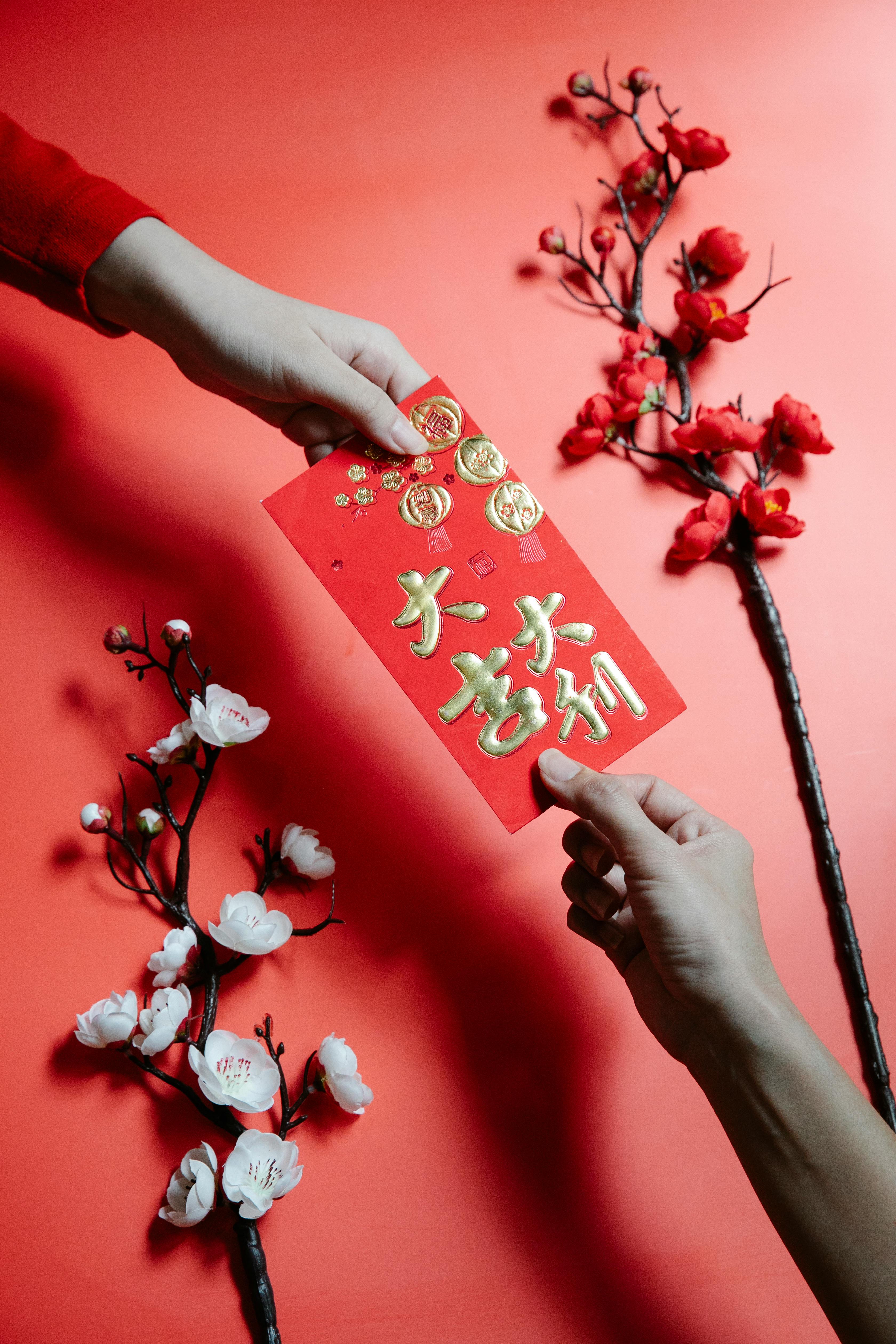 people holding a red envelope