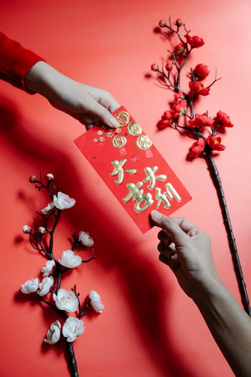 People Holding a Red Envelope
