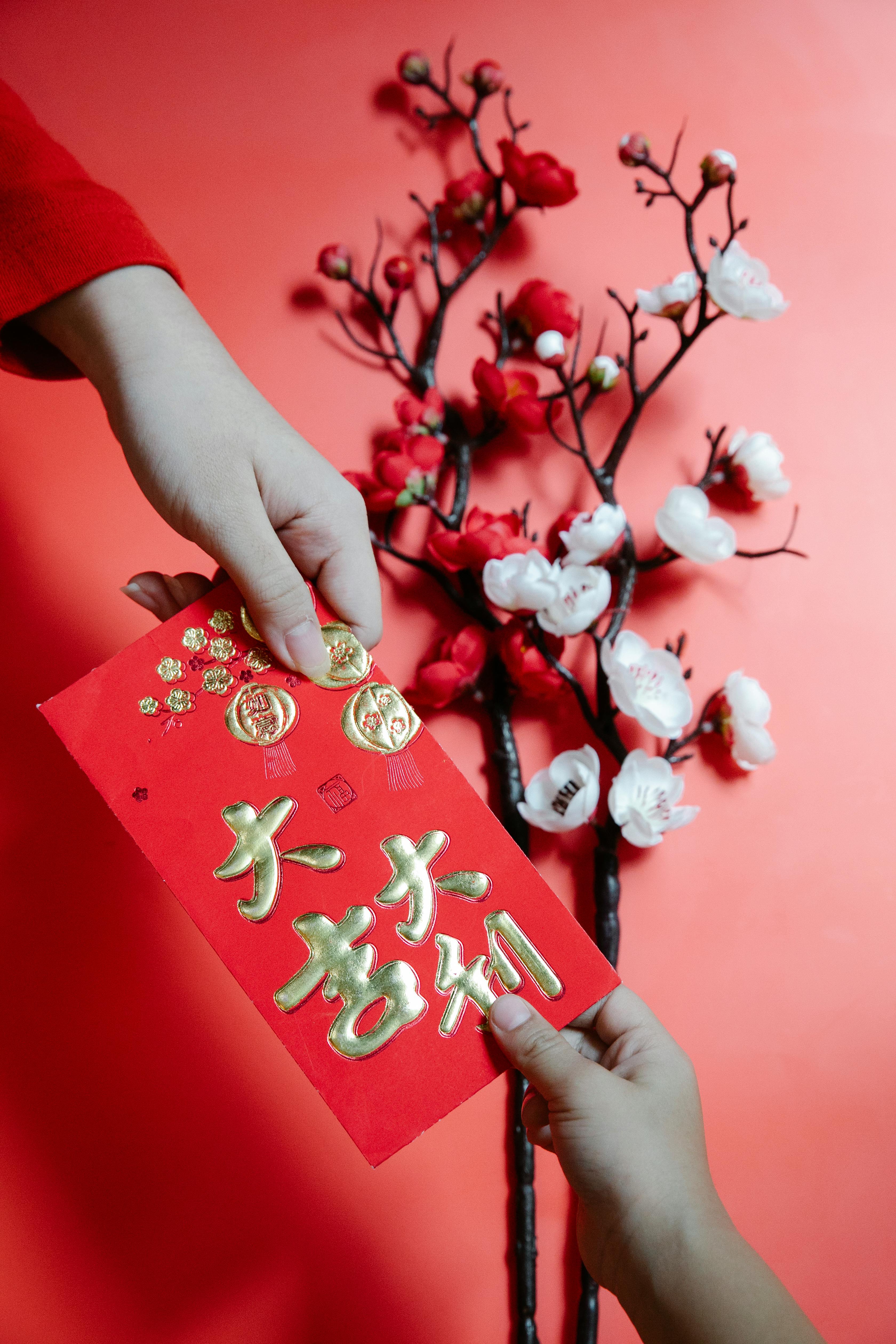 people holding a red envelope