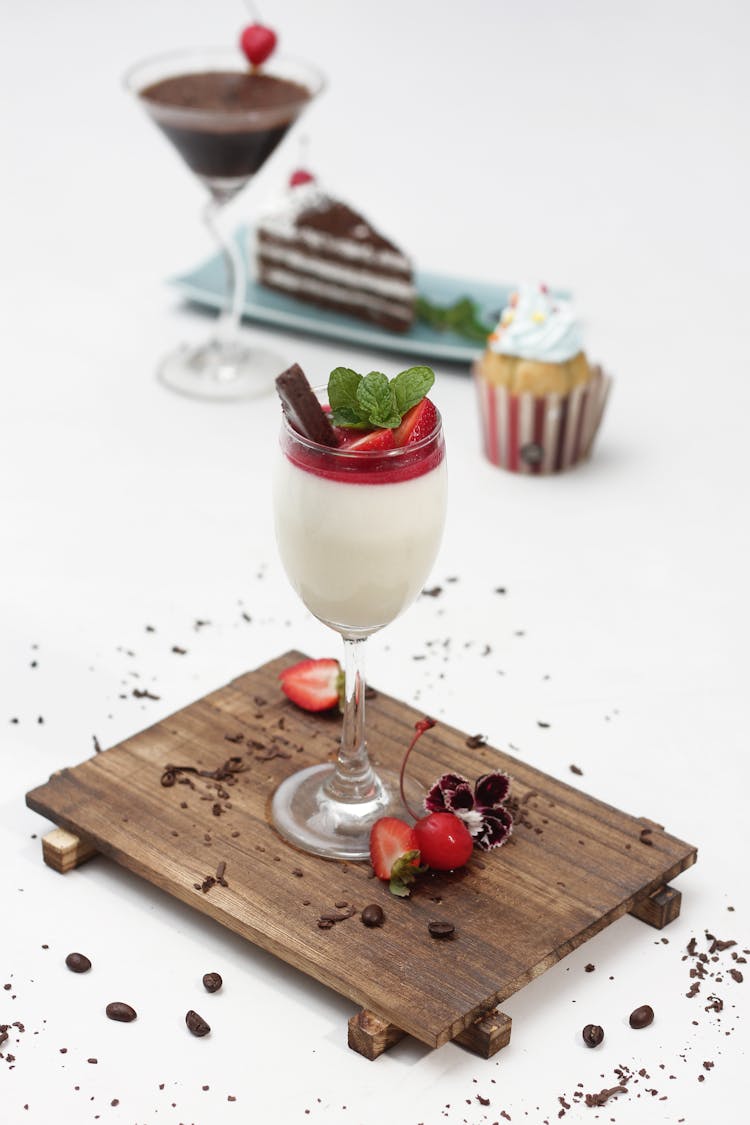Cheesecake With Strawberry Mousse Served In Cocktail Glass With Chocolate