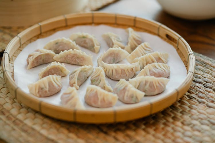 Fresh Dim Sum In Bamboo Tray On Straw Mat