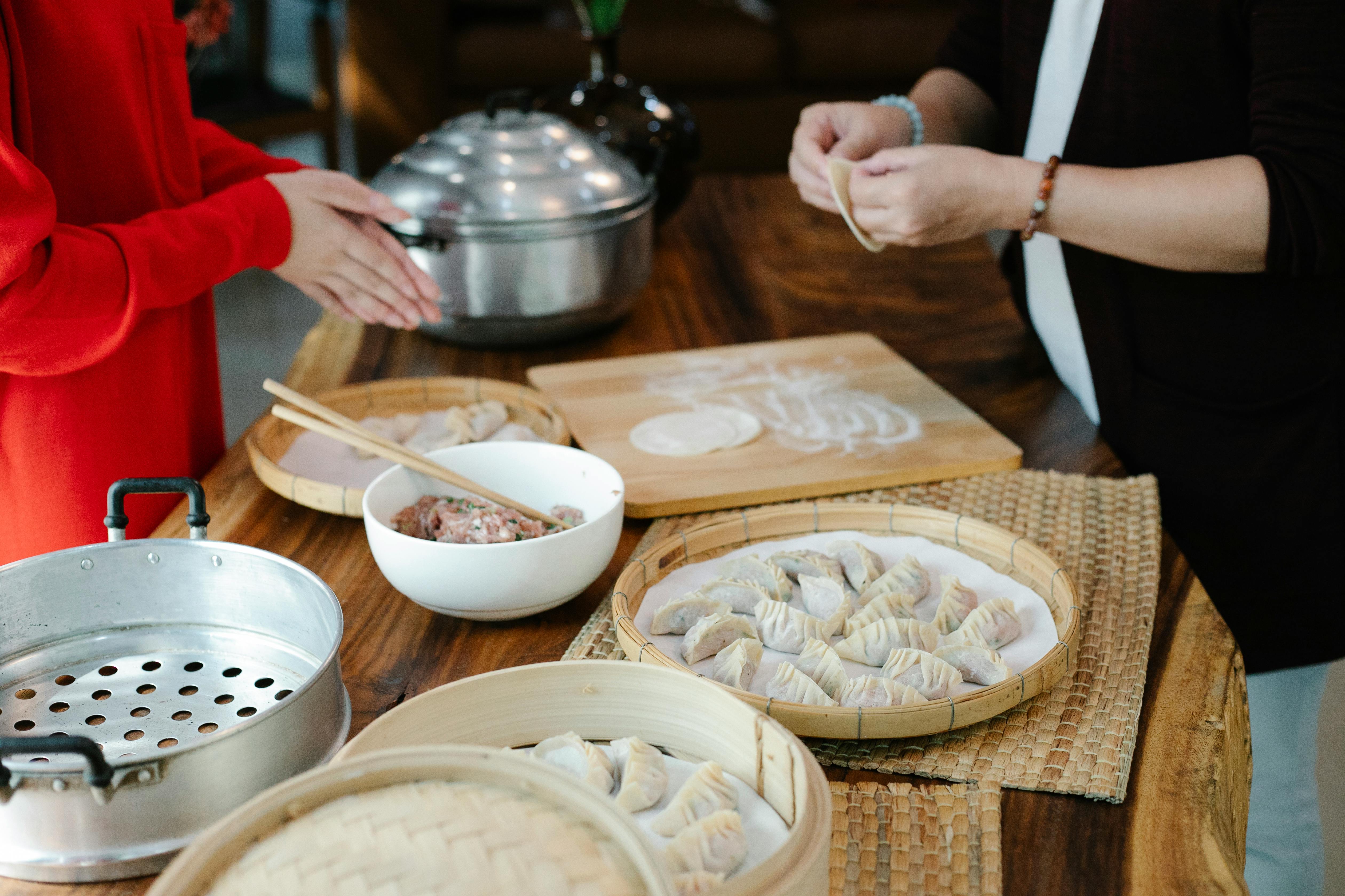 faceless women preparing dim sum at home