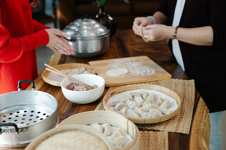 Faceless Women Preparing Dim Sum At Home