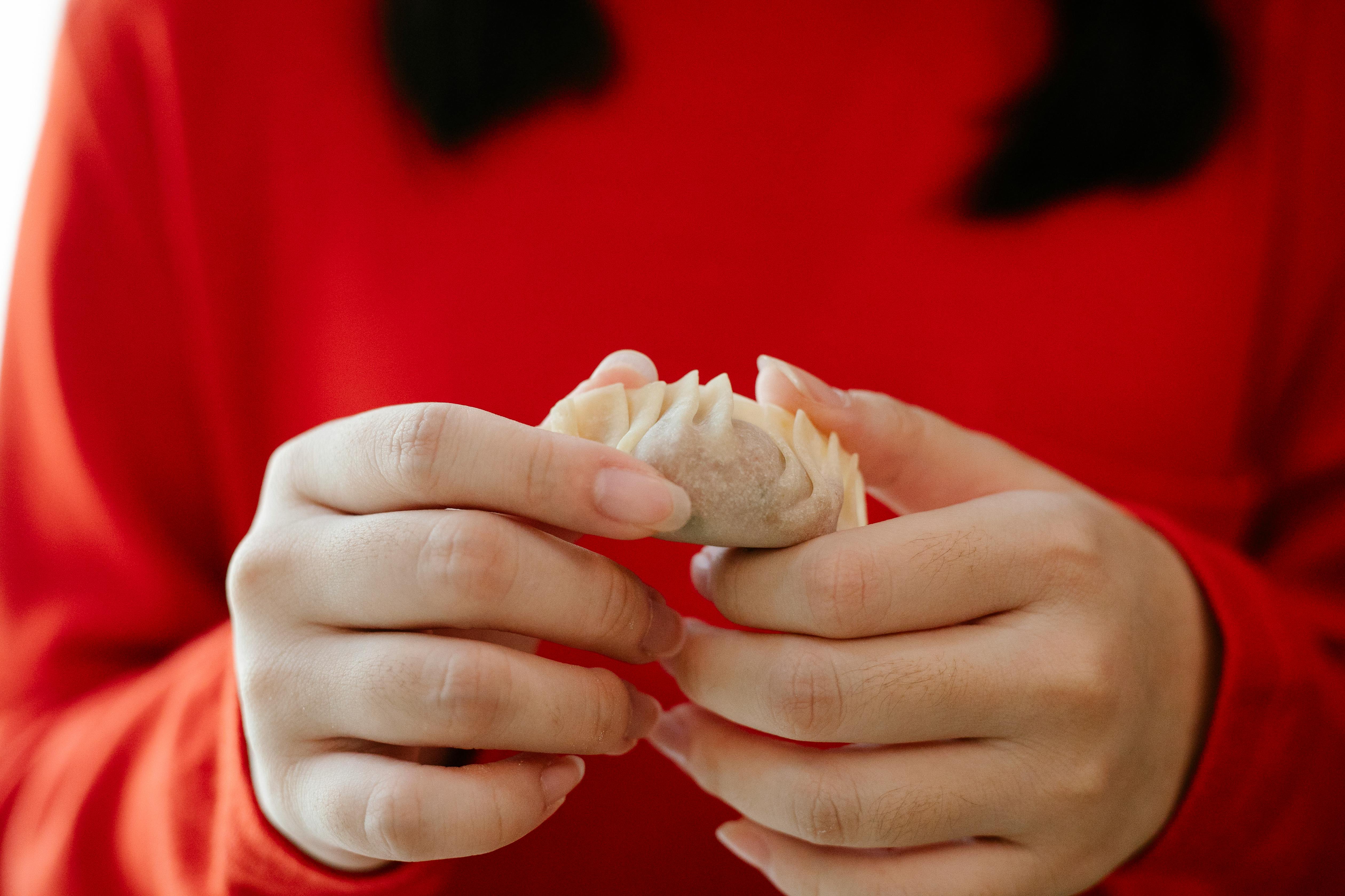 crop woman with jiaozi dumpling at home