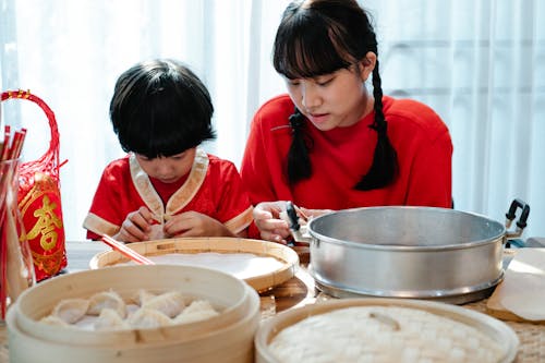 Siblings Learning How to Make Dumplings