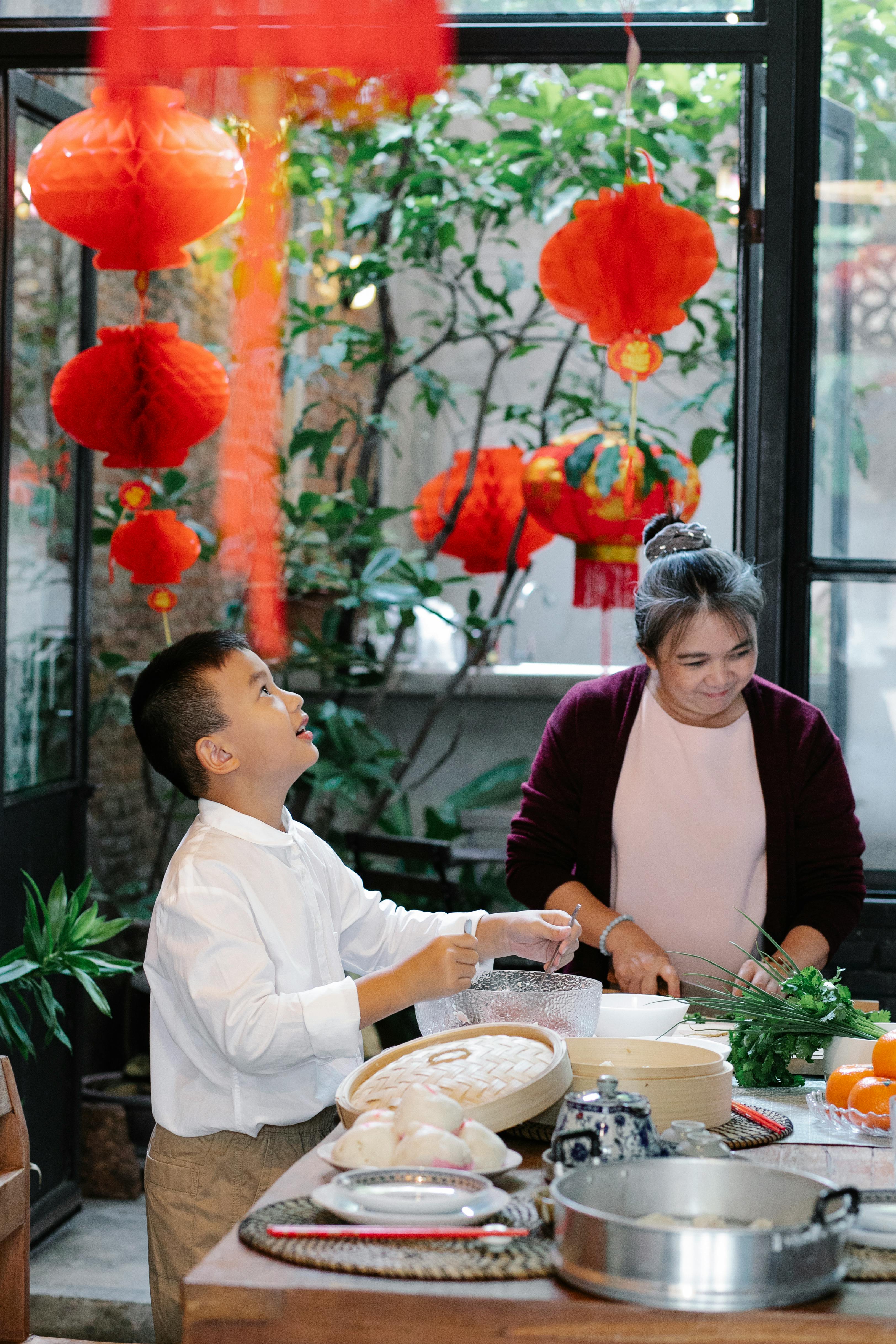 excited asian boy mixing ingredients for dumplings