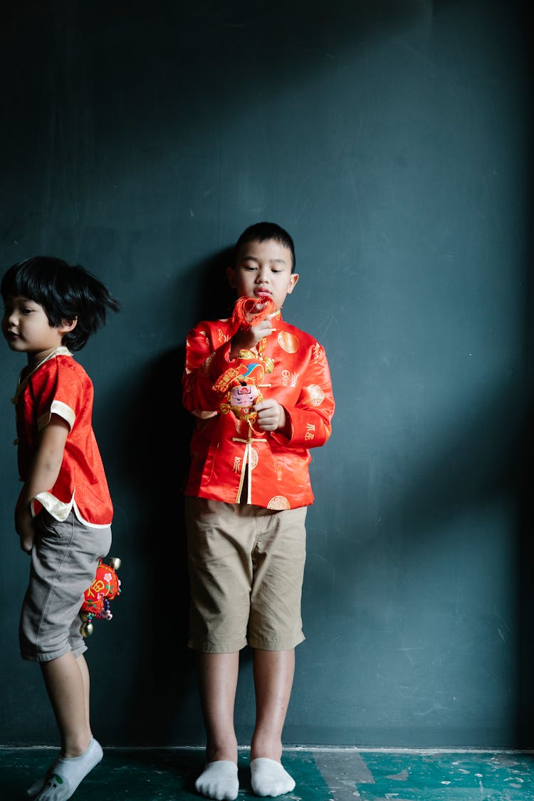 Boys In Red Clothes Holding Chinese Trinkets