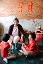 Asian grandmother giving red envelopes for children