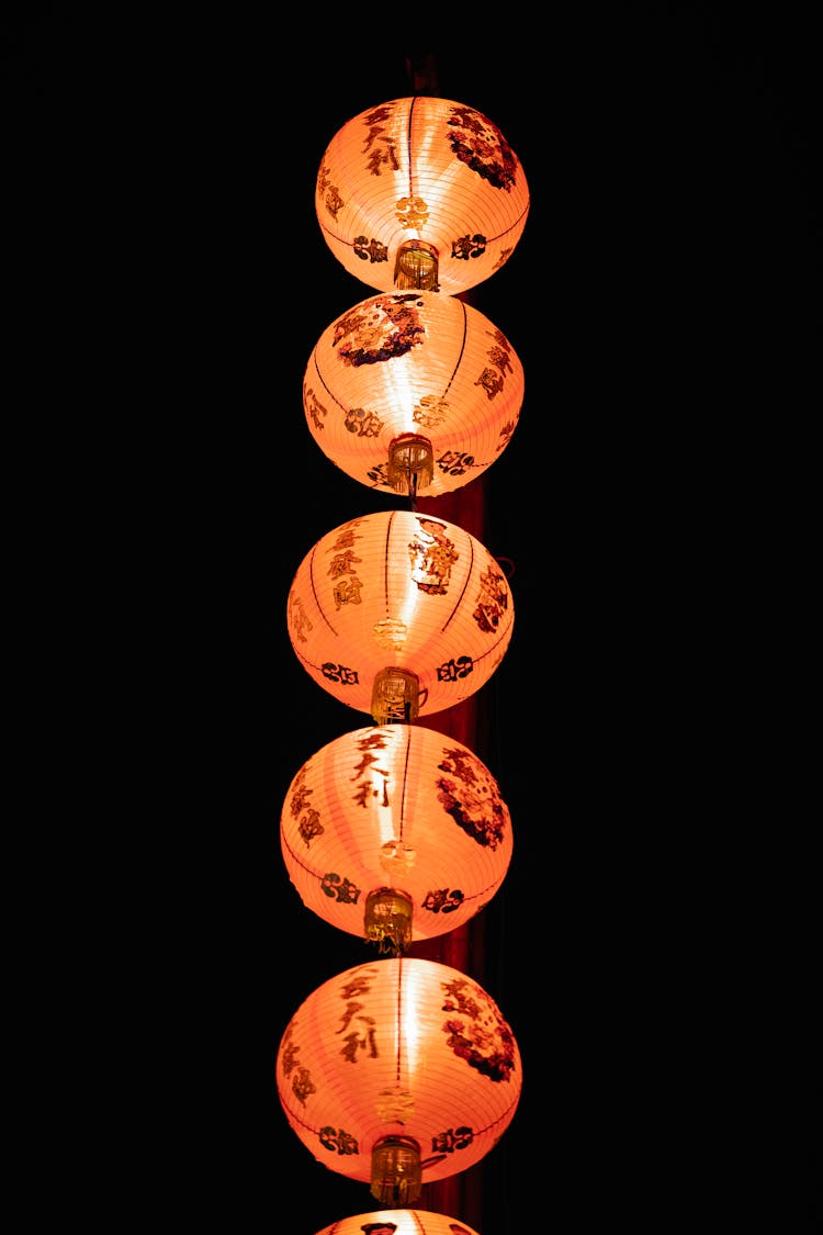 Row Of Chinese Lanterns With Fire In Darkness