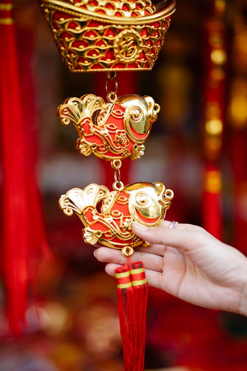 Free Woman touching golden traditional Chinese New Year decoration Stock Photo