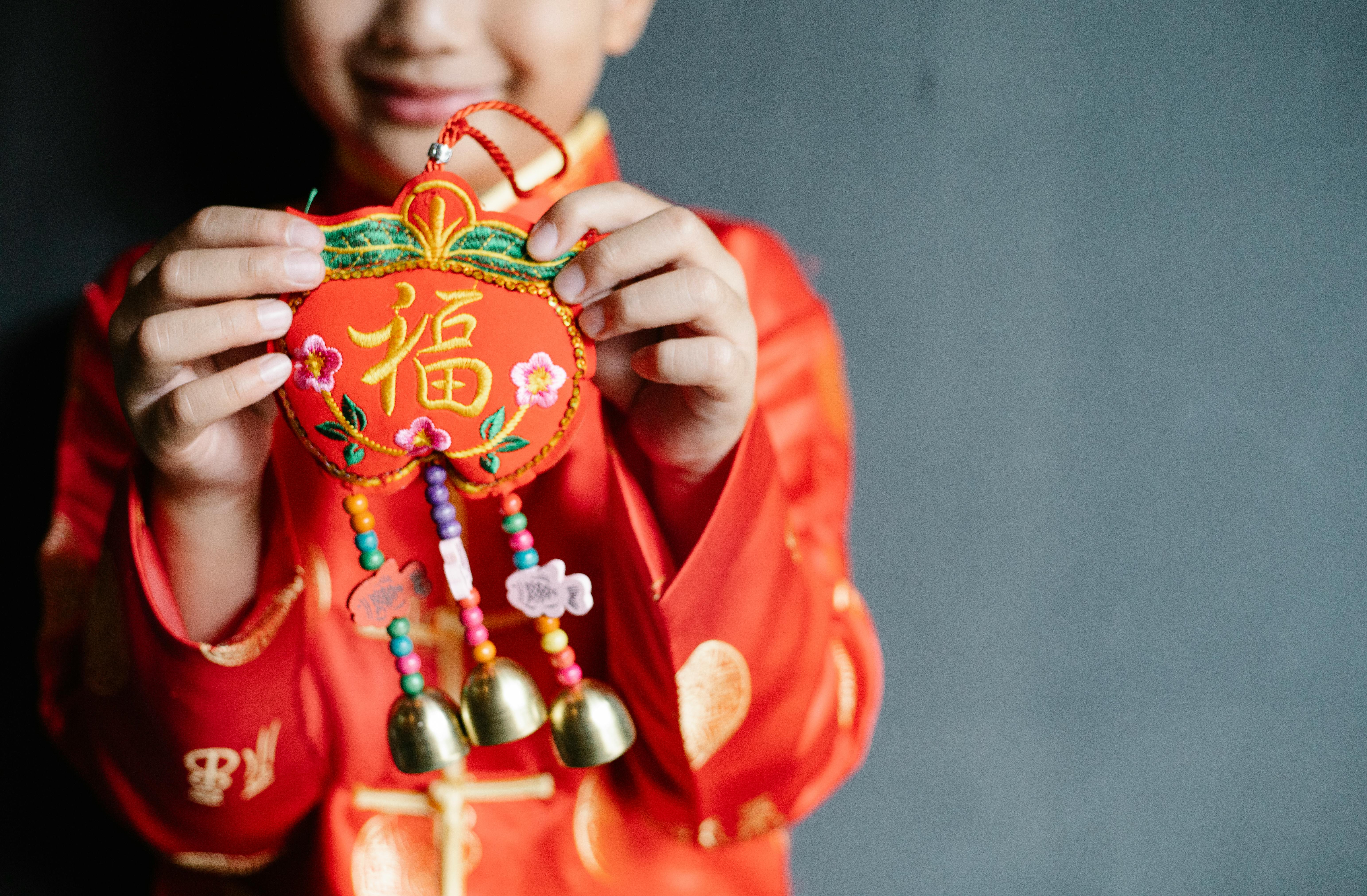 boy in traditional outfit with decorative bells