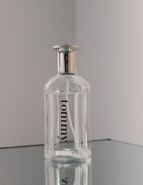 Free Minimalist perfume bottle in a studio shot with reflective surface and neutral tones. Stock Photo