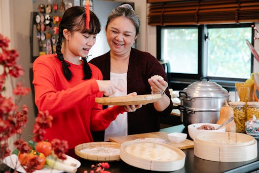A joyful moment in the kitchen as a granddaughter and grandmother prepare dumplings, celebrating tradition.