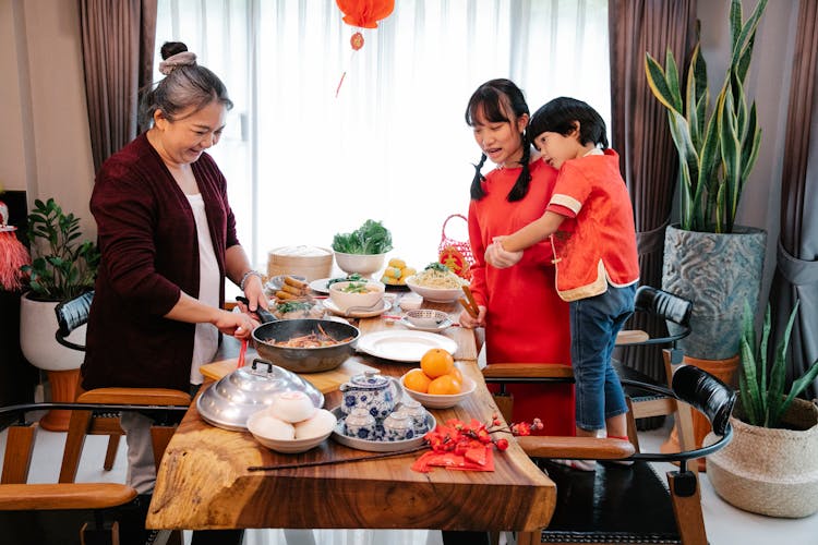 Positive Asian Woman Cooking Chinese Food For Festive Occasion