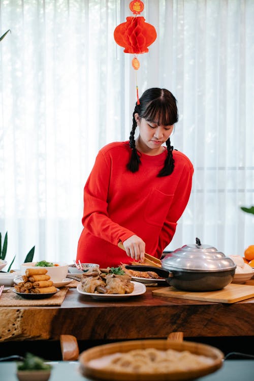 Asian teen serving delicious food during New Year holiday
