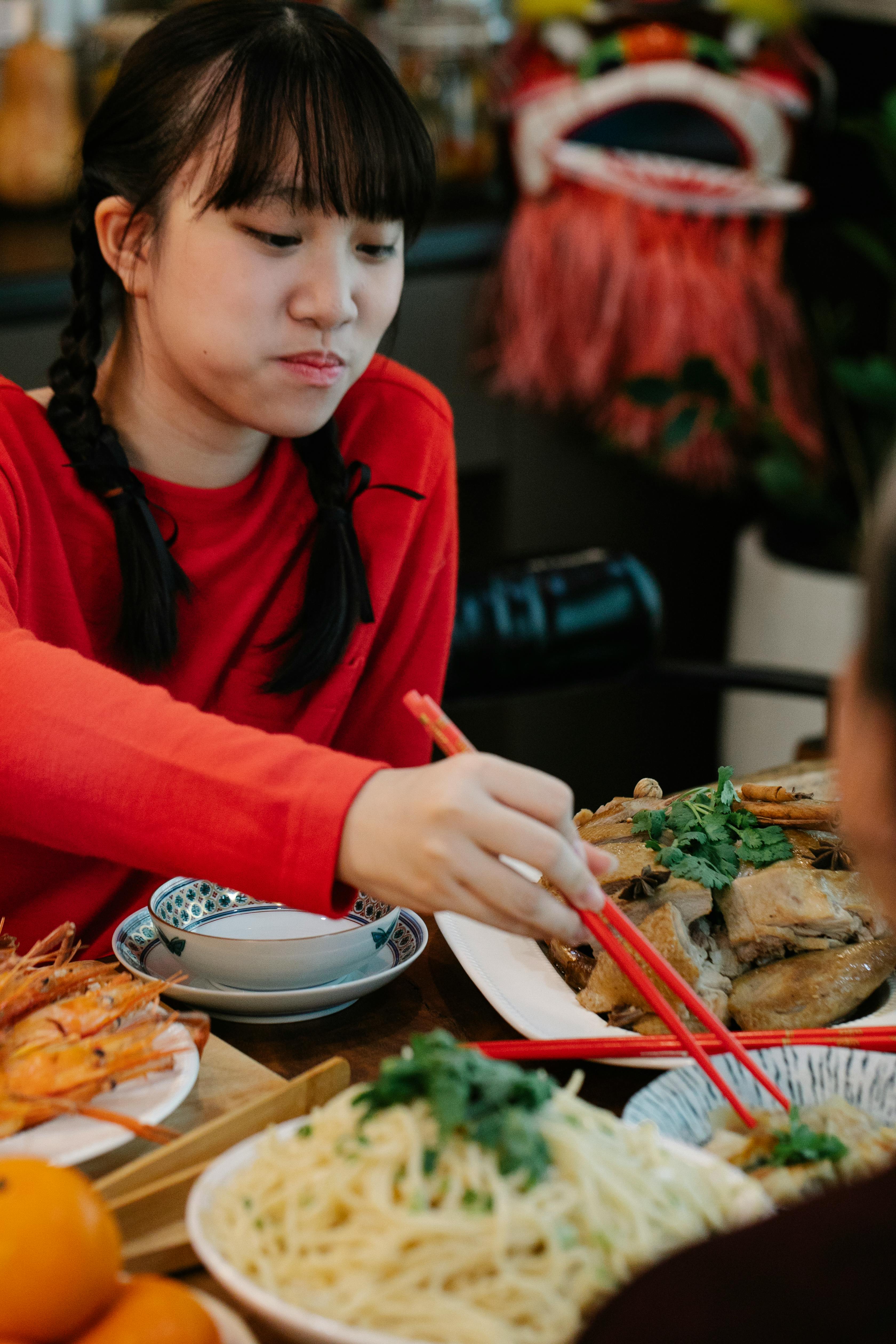 asian teenager serving dim sum at home