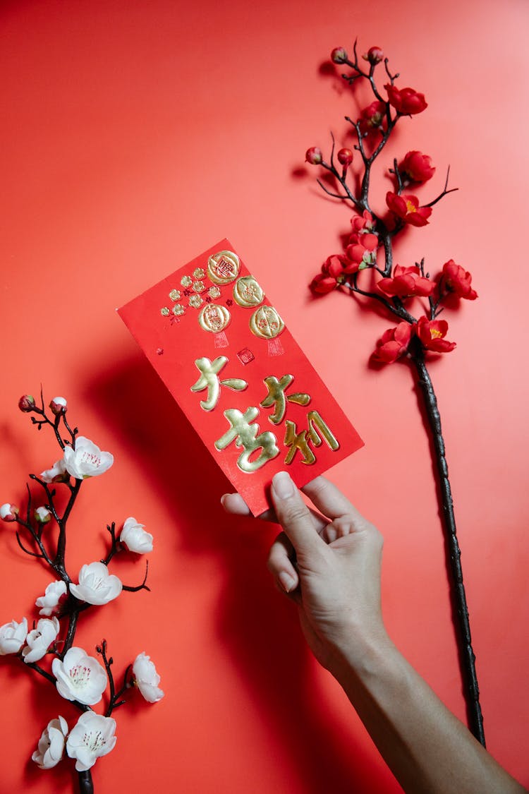 A Person Holding A Red Envelope