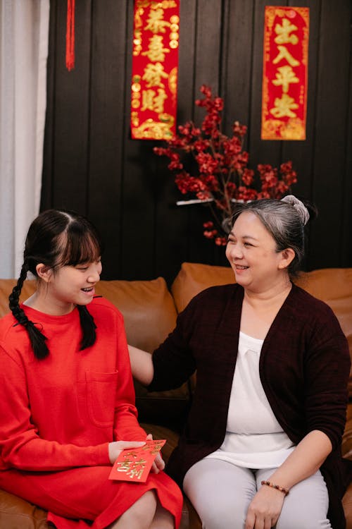 A Grandmother Sitting on the Sofa with Her Granddaughter