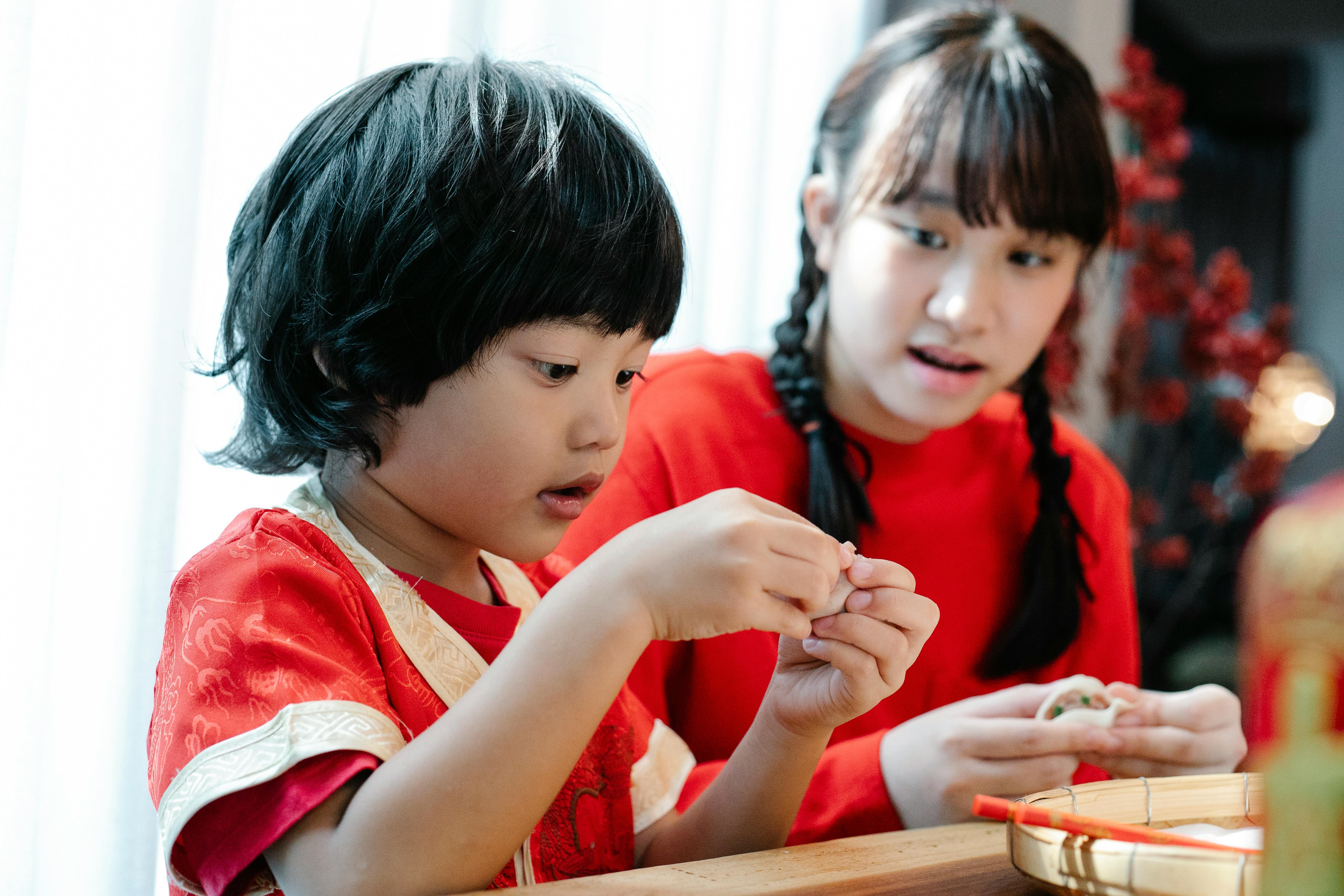 siblings learning how to make dumplings