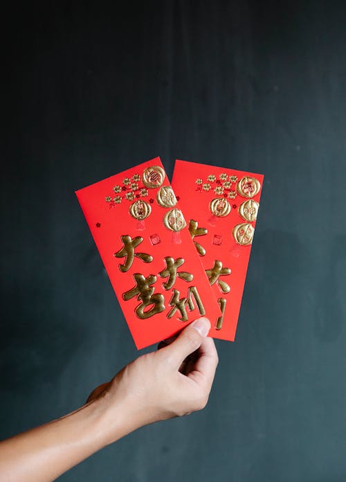 A Person Holding Red Envelopes