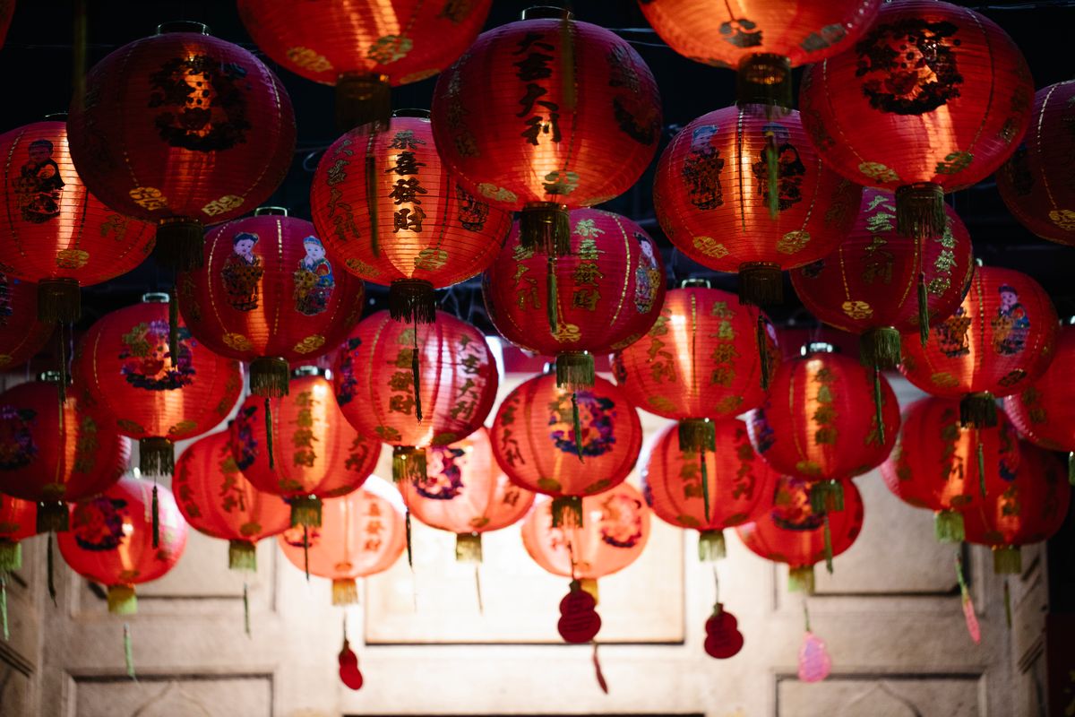 Traditional red Chinese lanterns glowing against a night sky