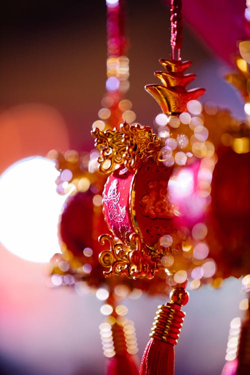 Traditional ornamental Chinese red decorations with golden details hanging on street during Spring Festival celebration