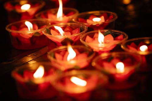 Burning candles on street at night