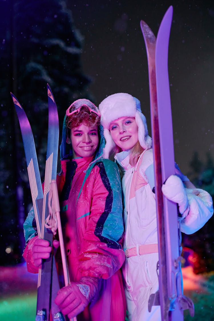 Two Women Holding Skis