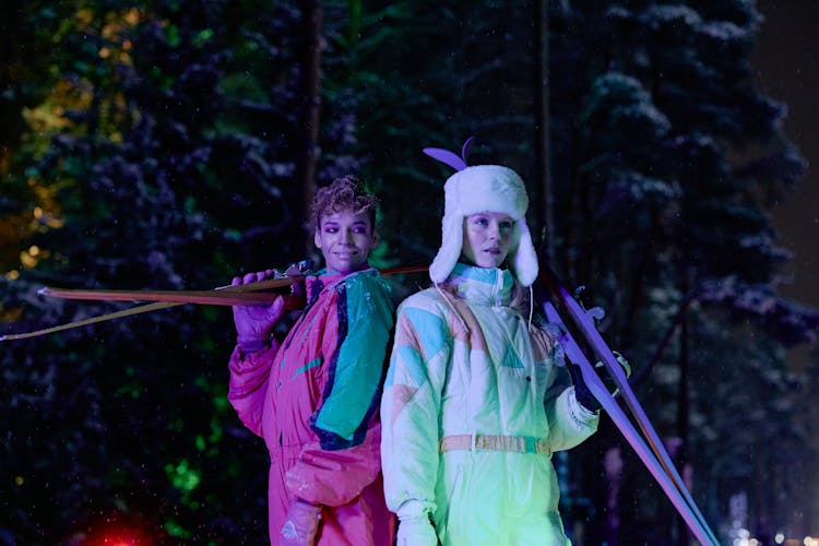 Two Women Holding Skis