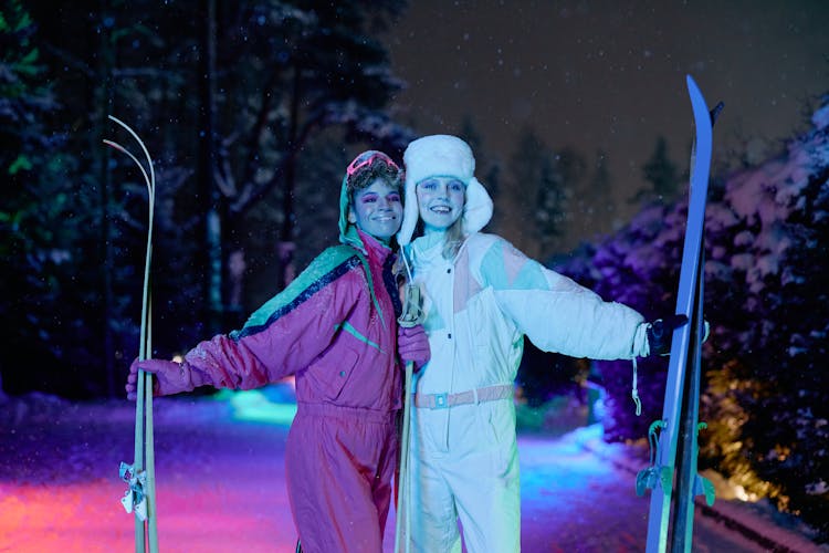 Women Holding Skis And Ski Poles