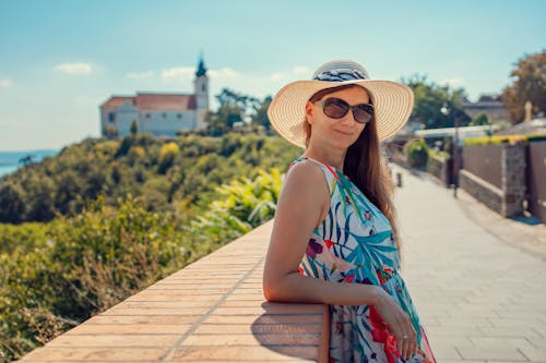 Woman with a Hat Wearing Sunglasses