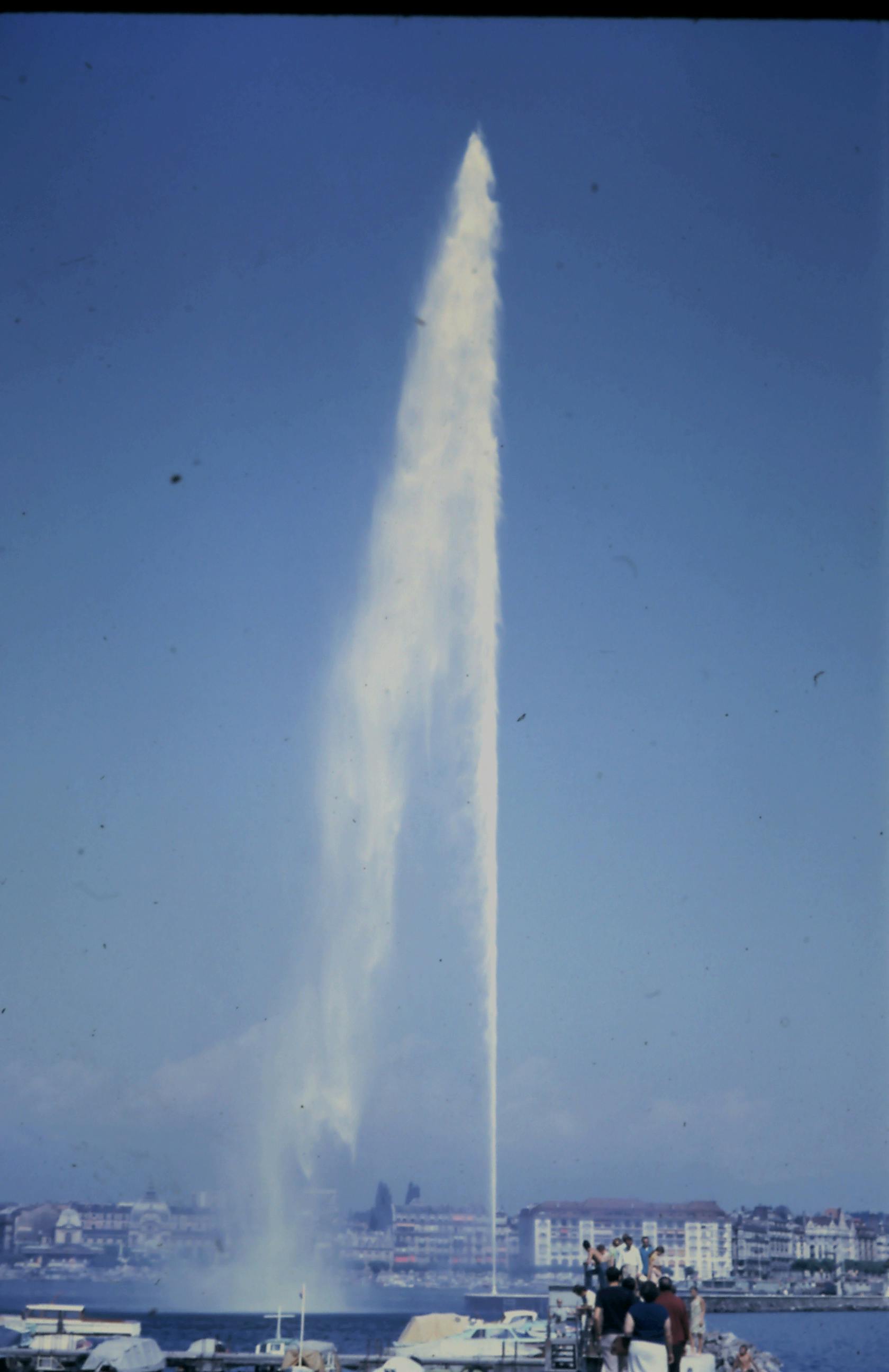 Stunning view of Jet d'Eau fountain in Geneva reaching into a clear blue sky.