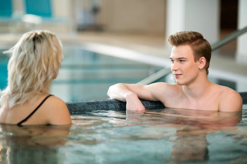 A Boy Talking to a Woman in a Swimming Pool