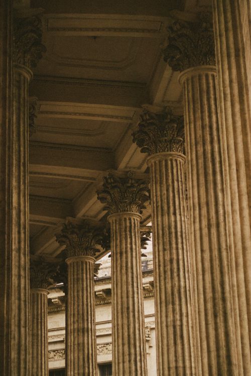 Free Elegant row of ornate classical columns in a historic building. Captivating monochrome tone. Stock Photo