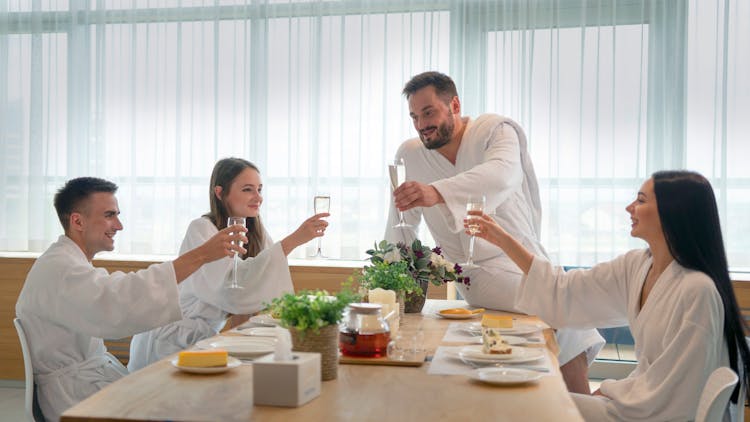 Friends In Bathrobes Doing A Toast