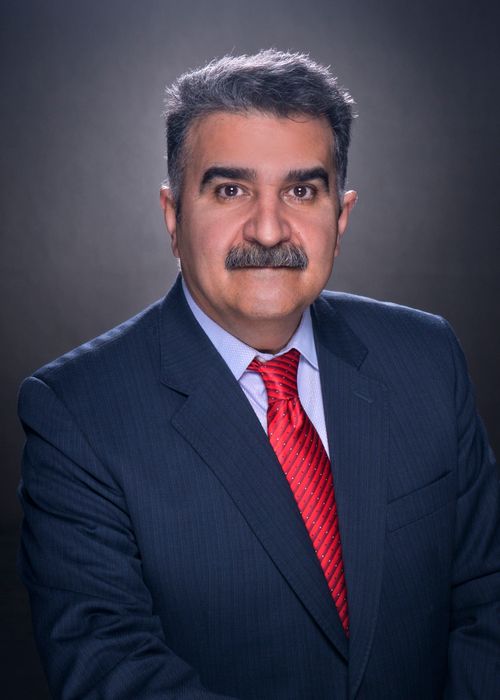 Free Portrait of a middle-aged man with a mustache in a blue suit and red tie, studio shot. Stock Photo