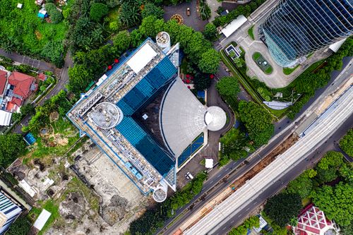 Free Drone shot capturing the vibrant architecture and greenery of Jakarta, Indonesia. Stock Photo