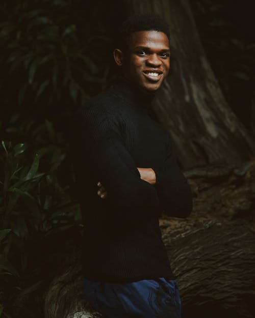 A Man in Black Sweater Smiling at the Camera