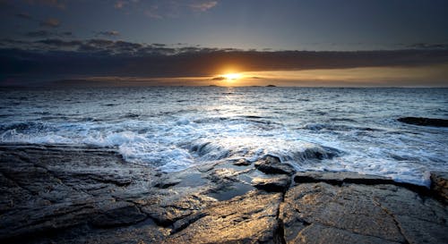 Free Sunset View from the Rocky Shore Stock Photo